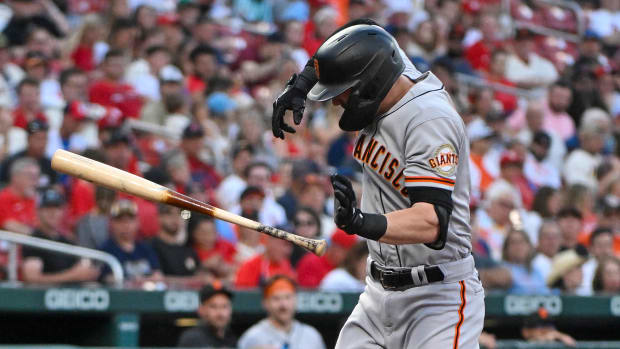 Mitch Haniger winces after Jack Flaherty's pitch breaks his forearm